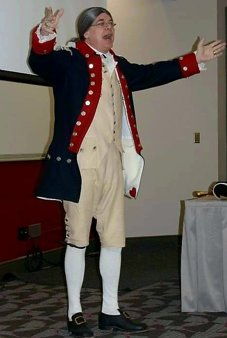 man in revolutionary war vetereans uniform with arms stretched out